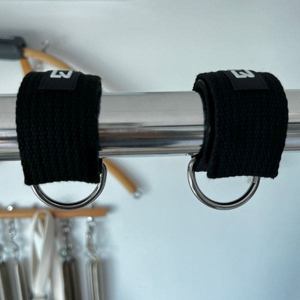 Close-up of Pilates bar cuffs supporting 80 kg hanging weight