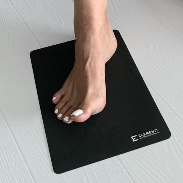 Foot placed on an ELEMENTS® Non-Slip Pad on the floor