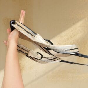 ELEMENTS® Pilates Loop and Roll in Mirage Gold shown in use in the hands on a Pilates Reformer